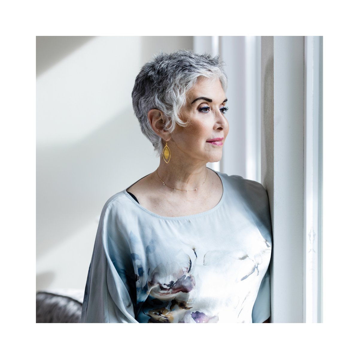 Woman looking thoughtfully out a window